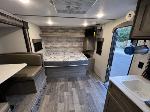 View of Dinette Slide, Main RV Queen, entry and kitchen area. 